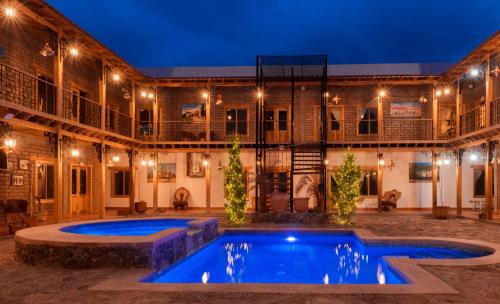a pool in front of a building at night at Hacienda Don Armando Boutique & Spa in Creel