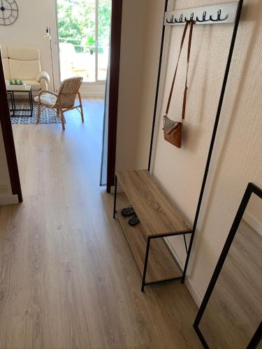 a room with a mirror and a wooden floor at Grand studio Clémenceau Vue mer 3 étoiles in Pléneuf-Val-André