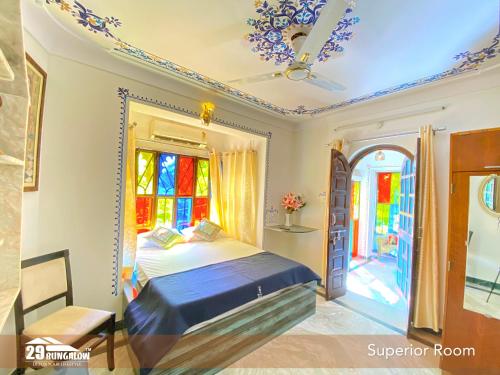 a bedroom with a bed and a window at 5BR Rajkarn Boutique Villa by 29Bungalow in Udaipur