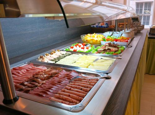 a buffet line with many different types of food at Pertschy Palais Hotel in Vienna