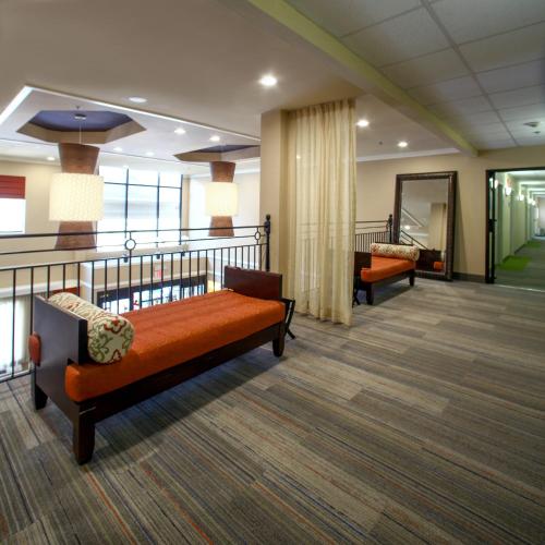 a hospital room with two beds and a mirror at Holiday Inn Express Hotel & Suites - Atlanta/Emory University Area by IHG in Decatur