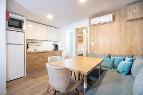 a kitchen and dining room with a table and a couch at Camping Inntal in Wiesing