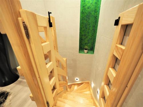 a room with wooden stairs and a window at VIP Apartamenty Stara Polana in Zakopane