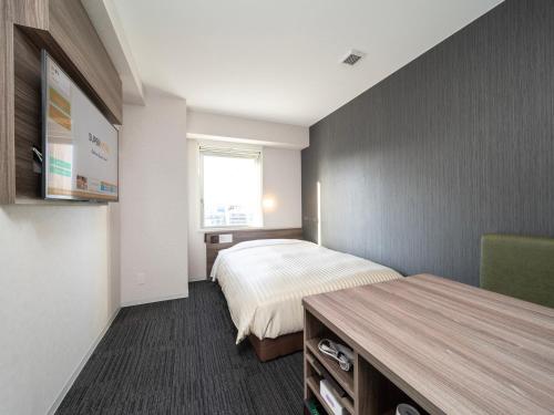 Postel nebo postele na pokoji v ubytování Super Hotel Hiroshima Yagenboridori
