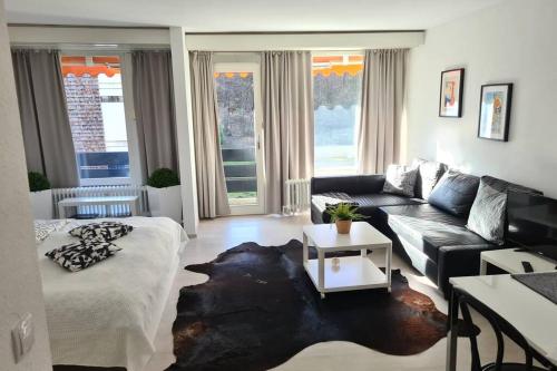 a living room with a couch and a living room with at Jutta Deluxe Apartment #301 in Bad Reichenhall