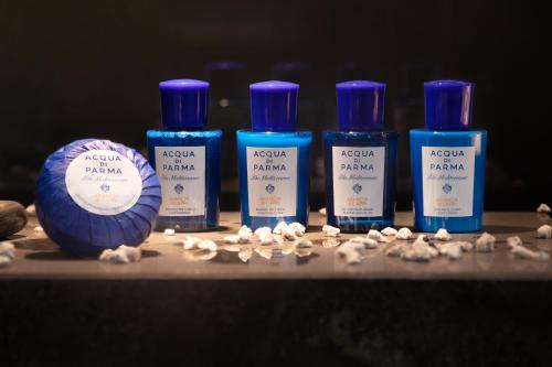 a group of four bottles of soap and a pile of pills at InterContinental Shanghai Wonderland by IHG in Songjiang