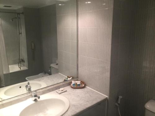 a bathroom with a sink and a mirror at Amarante Pyramids Hotel in Cairo