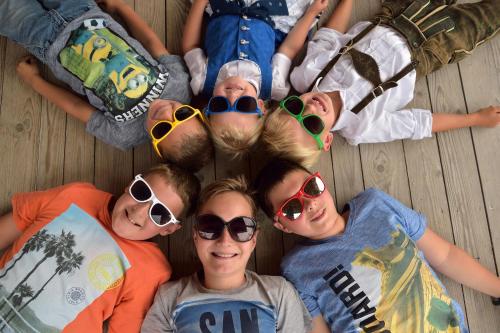a group of people laying on the floor wearing sunglasses at Reiterhof Suassbauer in St. Wolfgang