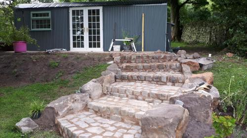 a set of stone steps in front of a house at The Owl Hoot in Ipstones