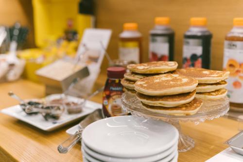 a stack of pancakes on a plate on a counter at Hotel Giulietta e Romeo ***S in Verona