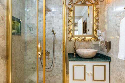 a bathroom with a sink and a shower at Begonville Mansion Oldcity in Istanbul