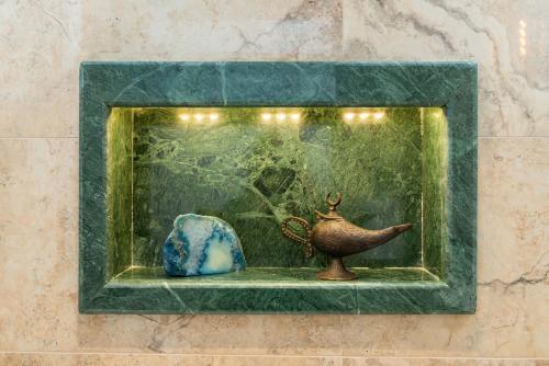 a picture of a vase and a jug in a window at Begonville Mansion Oldcity in Istanbul