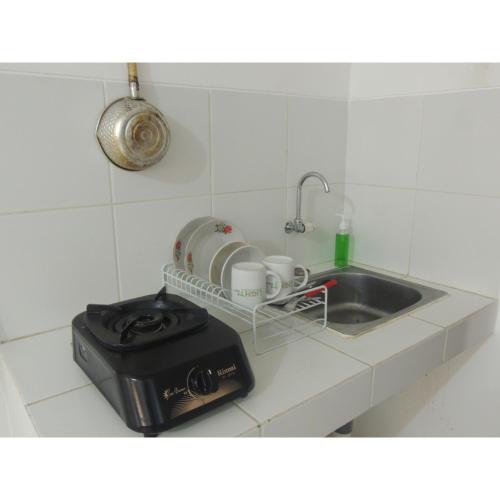 a kitchen counter with a sink and a toaster at Reva Room on Gunung Putri Square Apartment in Bogor