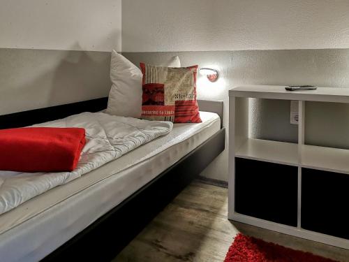 a bed with pillows on it in a room at Hahnenklee Ferienpark 409 & 211 in Goslar