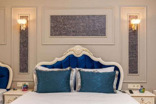 a bedroom with a blue and white bed with pillows at Begonville Mansion Oldcity in Istanbul