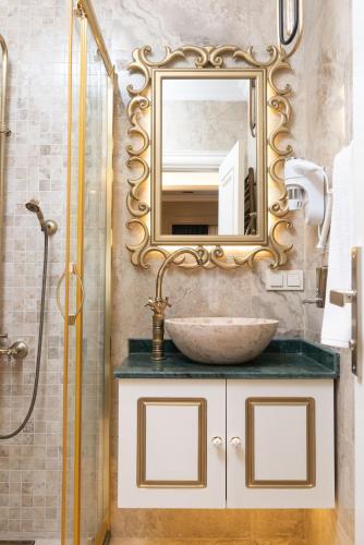 a bathroom with a sink and a mirror at Begonville Mansion Oldcity in Istanbul