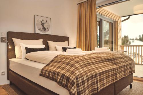 A bed or beds in a room at Adler Lodge D3 by AA Holiday Homes