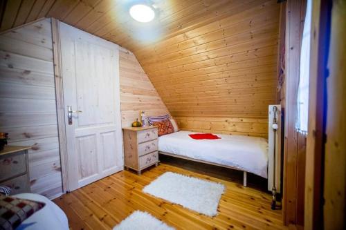 a bedroom with a bed in a wooden cabin at Kedra Village in Kédra