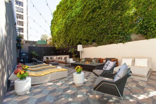 a patio with couches and chairs on a patio at Kimpton Hotel Palomar Los Angeles Beverly Hills by IHG in Los Angeles