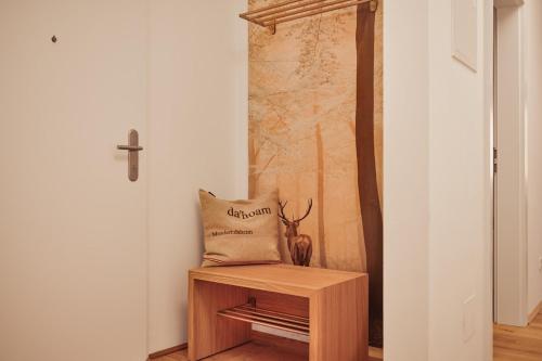 a bag sitting on a wooden stand next to a cross at die Tauplitz Lodges - Alm Lodge A13 by AA Holiday Homes in Tauplitz