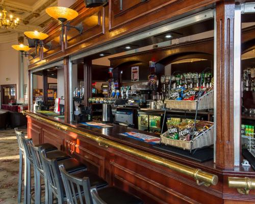 a bar with chairs and bottles of beer at The Grand Scarborough in Scarborough