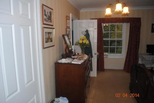 a room with a desk and a door with a window at Elmfield in Northlew