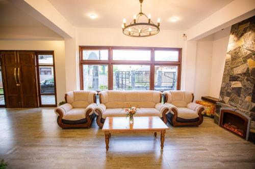 a living room with couches and a fireplace at Seasons Villa - Nuwara Eliya in Nuwara Eliya