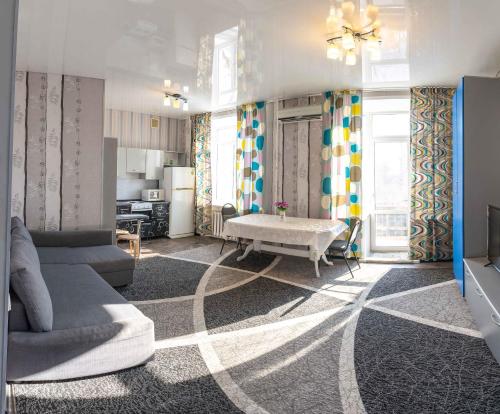 a living room with a couch and a table at Дом с прекрасным видом г Павлодар in Pavlodar