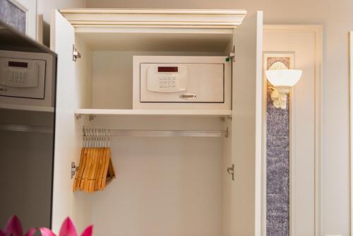 a kitchen with a microwave on a shelf at Begonville Mansion Oldcity in Istanbul