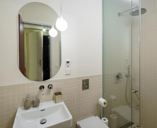 a bathroom with a sink and a mirror and a shower at MN6 Luxury Suites by Adrez in Prague