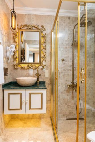 a bathroom with a sink and a mirror at Begonville Mansion Oldcity in Istanbul
