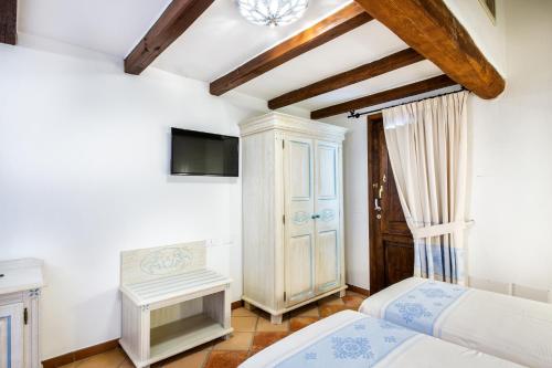 Ένα ή περισσότερα κρεβάτια σε δωμάτιο στο Hotel Costa Caddu