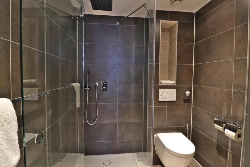 a bathroom with a shower and a toilet at XO Hotels Infinity in Amsterdam
