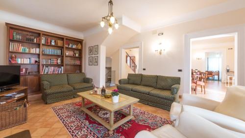a living room with couches and a coffee table at BORGO COLLE RIDENTE 13, Emma Villas in Camerino