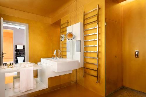 a bathroom with two sinks and a mirror at Sina Centurion Palace in Venice