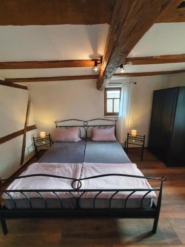 a bedroom with a large bed in a room at Ferienhaus Schmitt in Beltheim