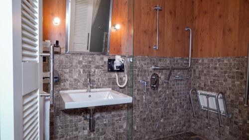 a bathroom with a sink and a shower at Koza Suite Hotel in Ankara
