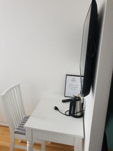 a tv sitting on top of a white table at Nora Stadshotell, Sure Hotel Collection by Best Western in Nora