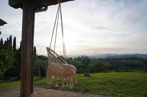 a hammock hanging from a porch with a view at Agriturismo Il Sarale - Umbria in Città di Castello
