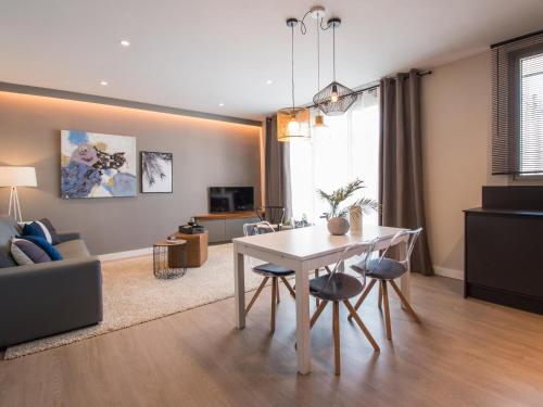 a living room with a white table and chairs at Sitges Spaces Seaside Beach Flat with Terrace in Sitges