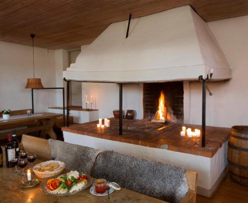 a living room with a fireplace and a table with candles at Biskops Arnö in Biskops Arnö