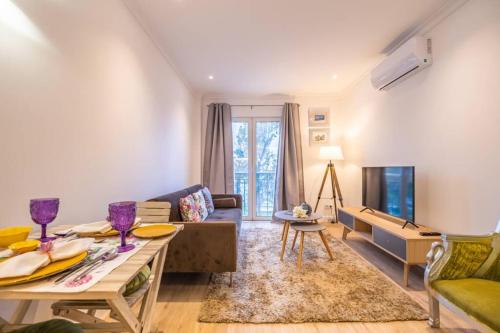 a living room with a couch and a table at Funchal Center Apartment II in Funchal