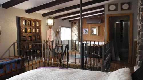 a bedroom with a bed with a iron gate at El Rincón de San José in Marjaliza