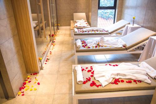 a row of beds in a room with flowers on the floor at Vamos Addis Hotel in Addis Ababa