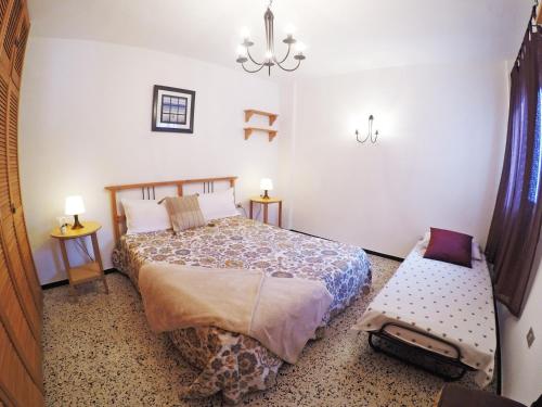 a bedroom with a bed and a bench in it at Fleitas Penthouse with terrace in San Andrés