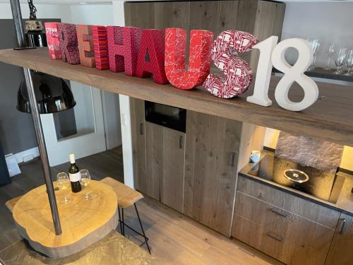 a wooden shelf with a happy sign and a table at Freihaus18**** in Bad Wiessee