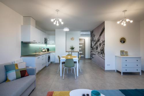 a kitchen and living room with a couch and a table at Stafétaház Apartmanok in Vác