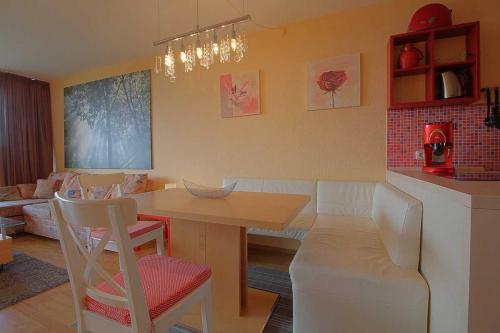 a kitchen with a table and chairs and a living room at Apartment 551 in Hohegeiß