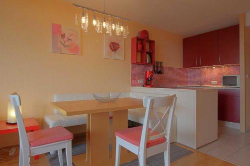 a kitchen with a table and two chairs and a table at Apartment 551 in Hohegeiß