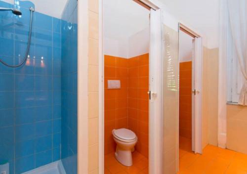 a bathroom with a toilet and a shower at A Casa di Amici in Palermo